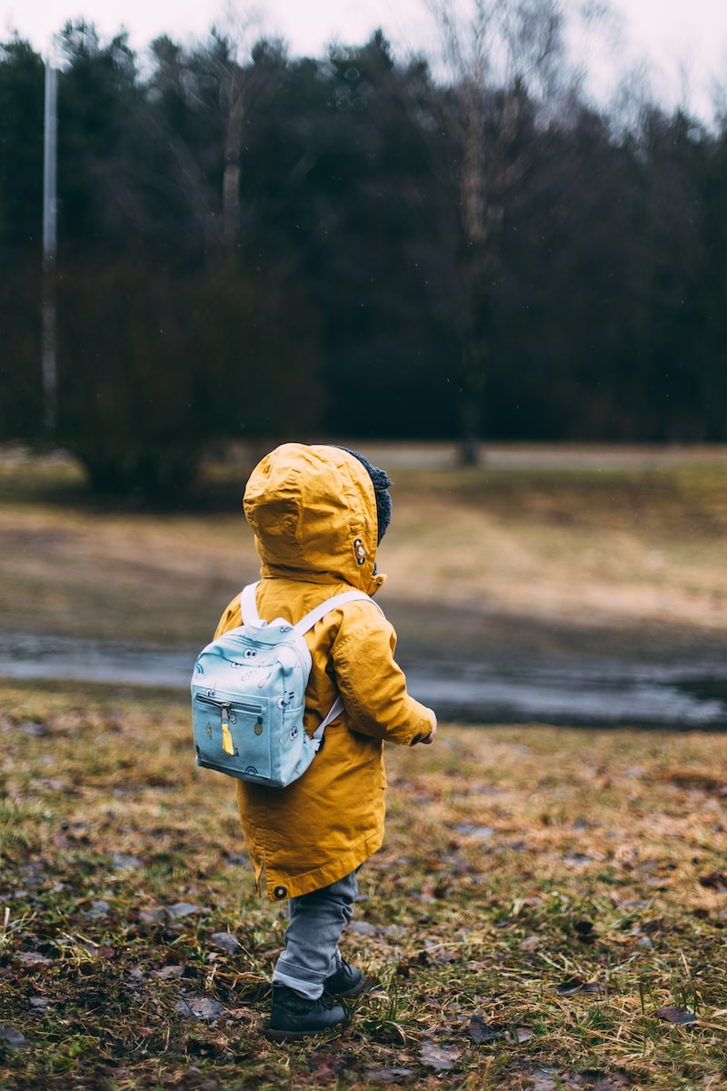 Photo by Daiga Ellaby shallow focus photo of toddler walking near river