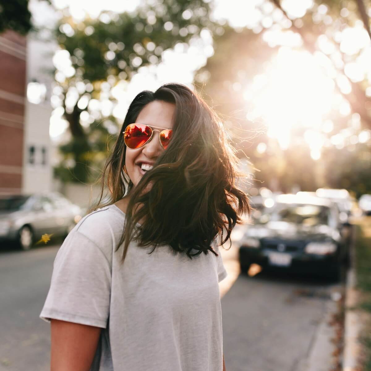 Photo by Matthew Hamilton woman wearing white T-shirt smiling